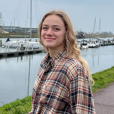 Taya-Ambrose-crop.jpg Tay in front of sidewalk and dock lined with small boats